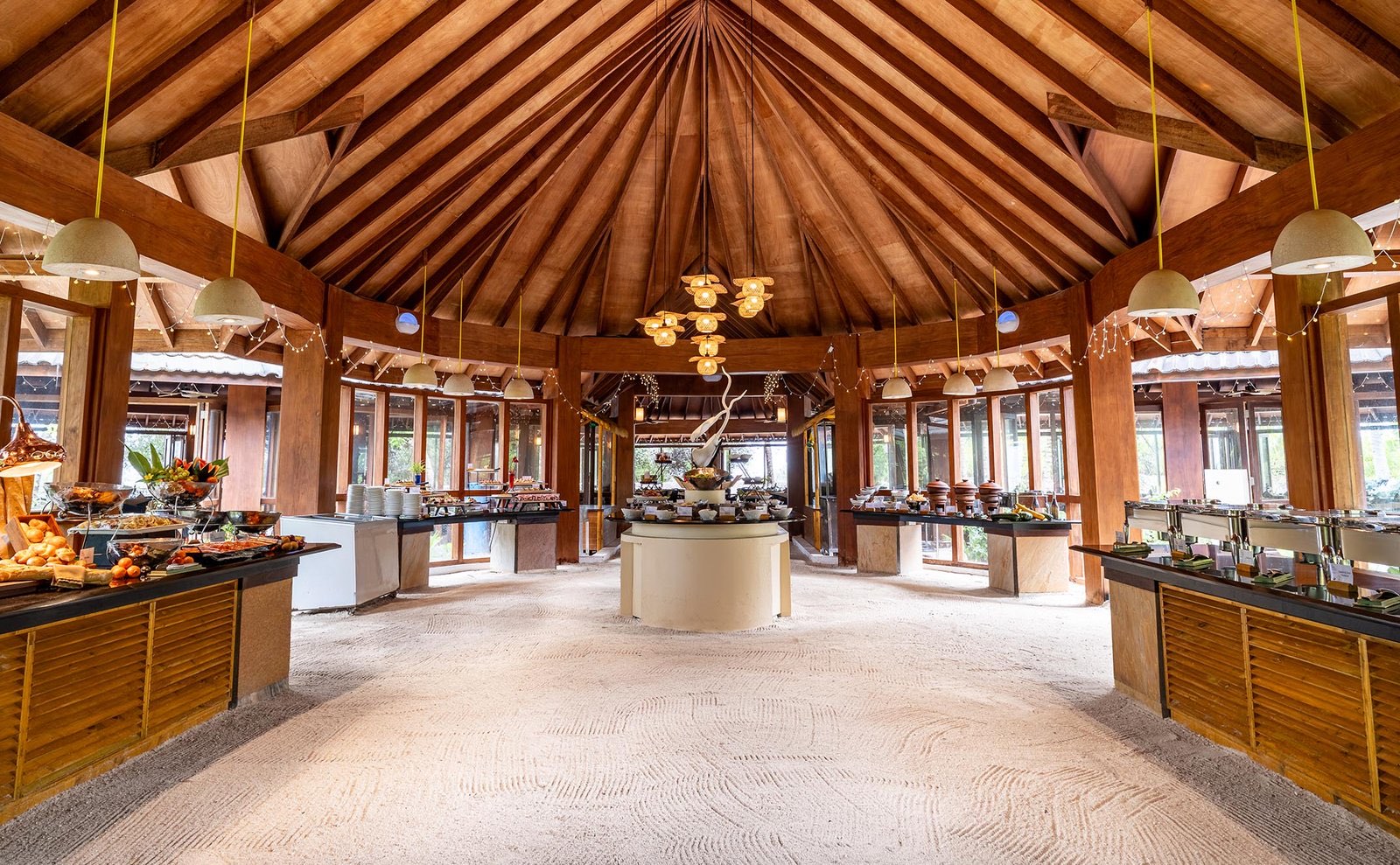 A buffet counter laid with dishes under warm light in the resort's restaurant.
